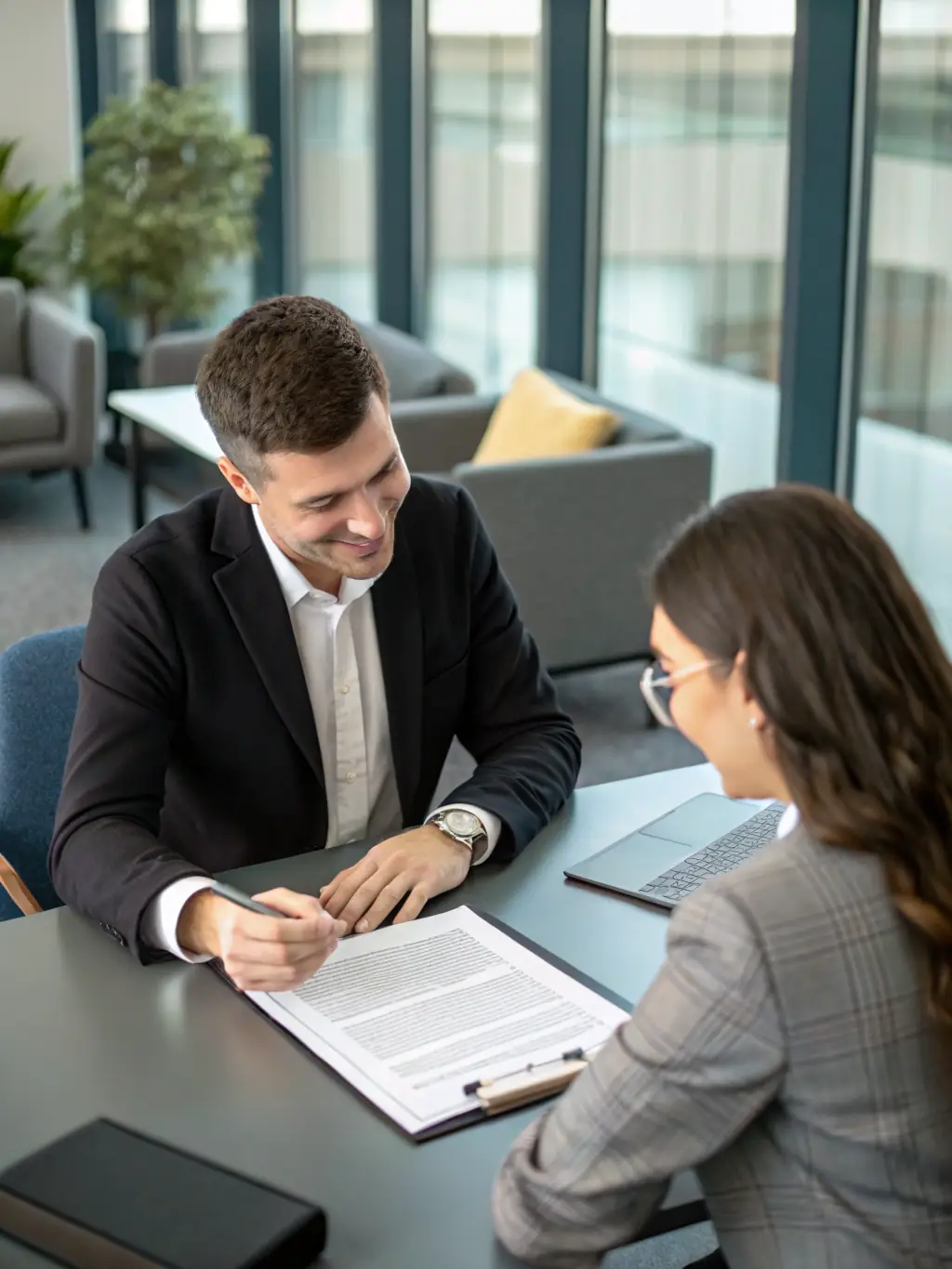 A photograph of a consultant reviewing documents with a business owner, highlighting personalized compliance assistance.